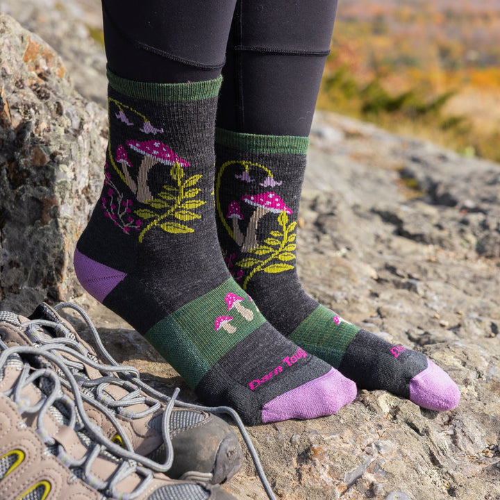 Person wearing Mellow Mushrooms socks in charcoal on mountain trail