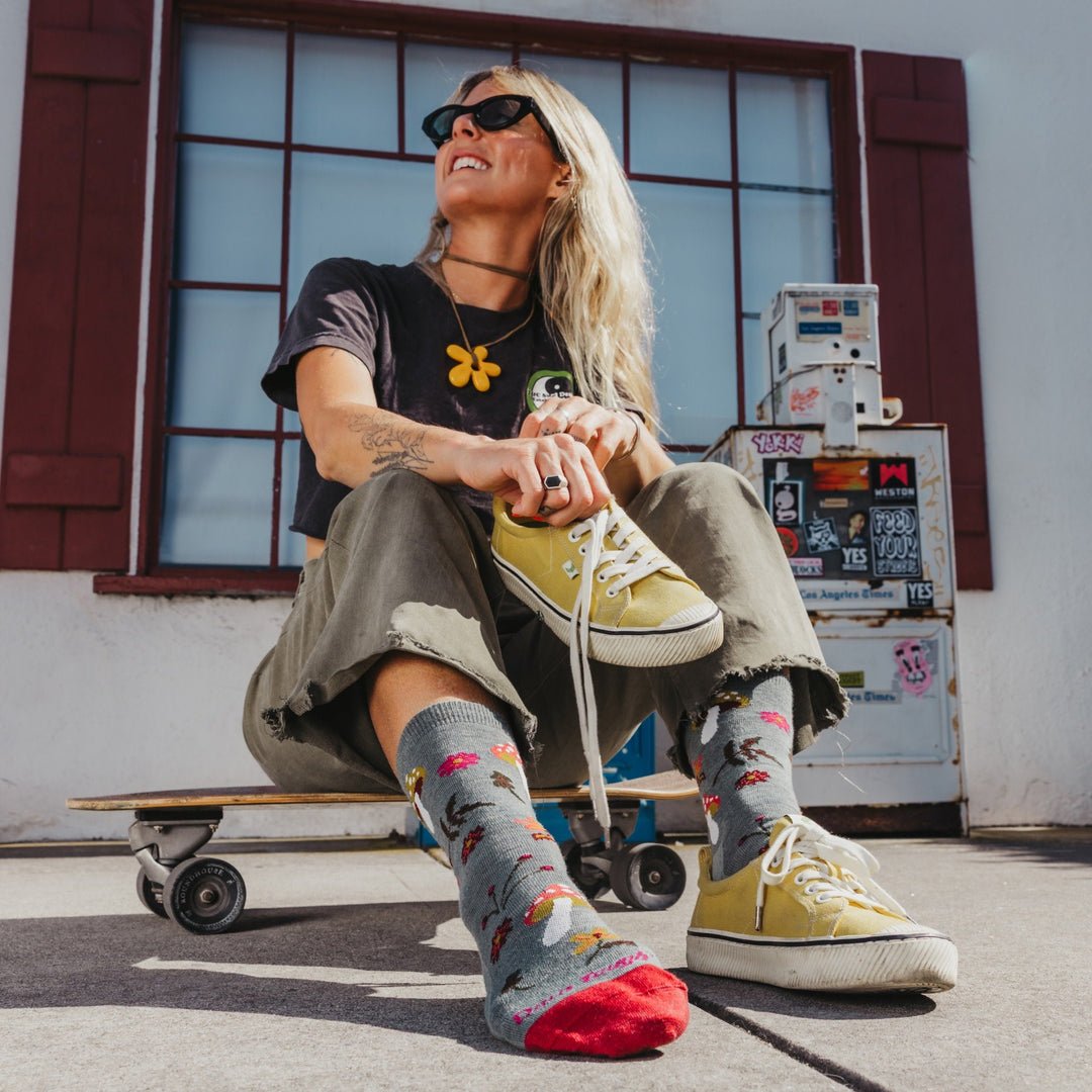 Shroom Bloom seafoam socks left foot detail on skateboard
