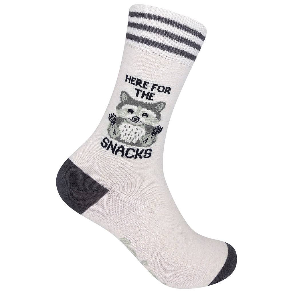Unisex raccoon crew socks, flat product shot of a cream sock with charcoal cuff stripes, heel and toe, a gray raccoon and the words Here for the Snacks.