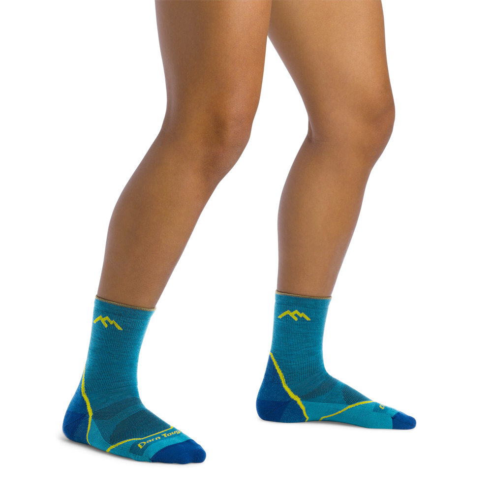 Kids' teal hiker micro crew socks worn on legs, front view