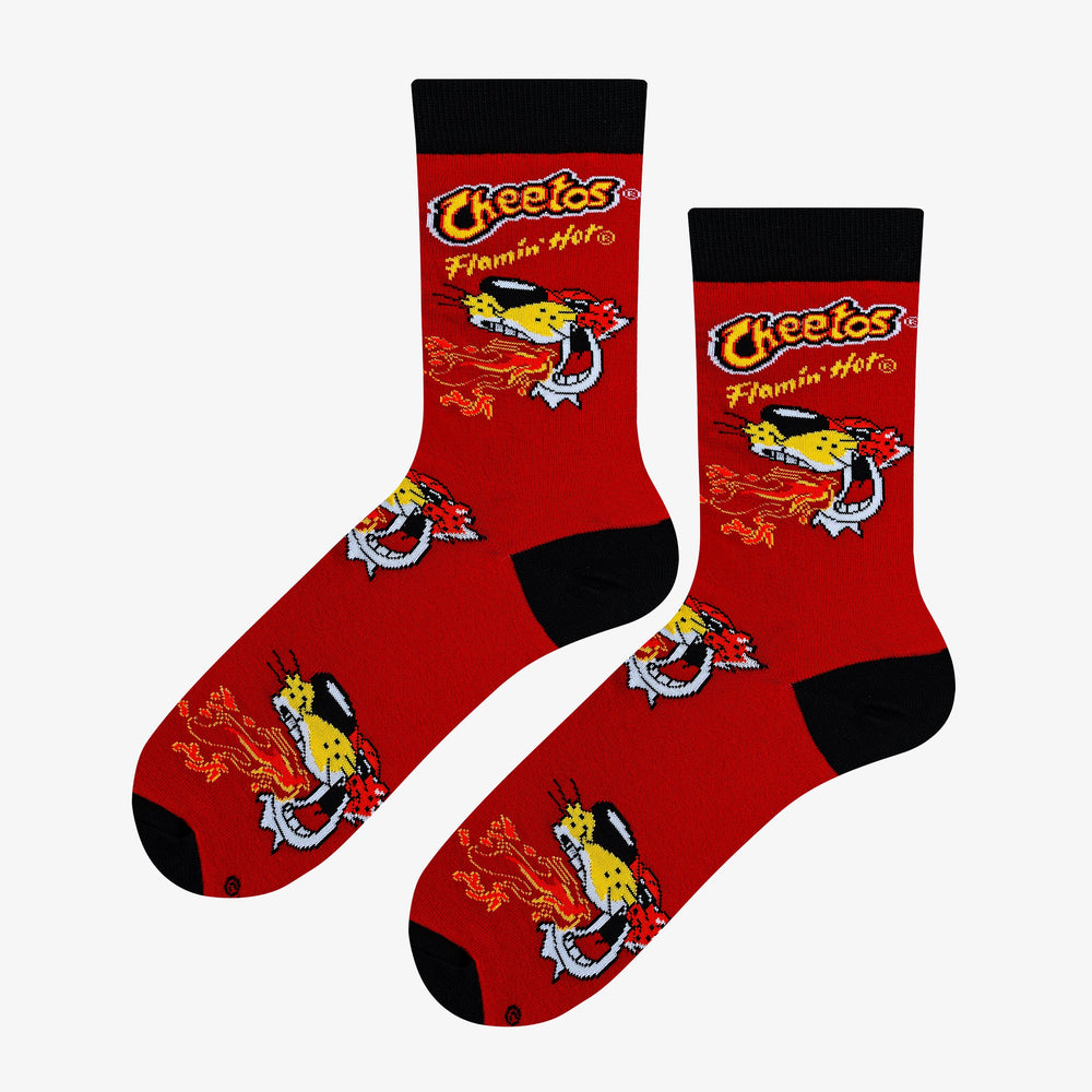 Women's Cheetos Flamin' Hot crew socks flat lay top view on red