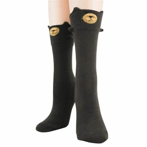 Women's 3D bear crew socks worn, black with golden bear face and 3D ears at the cuff