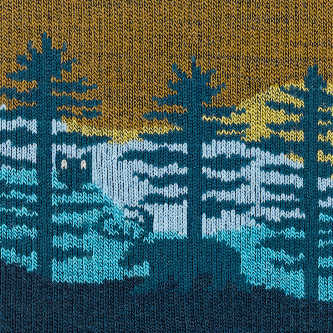 Close-up of the knitted pine forest and bear design on the northwoods sock