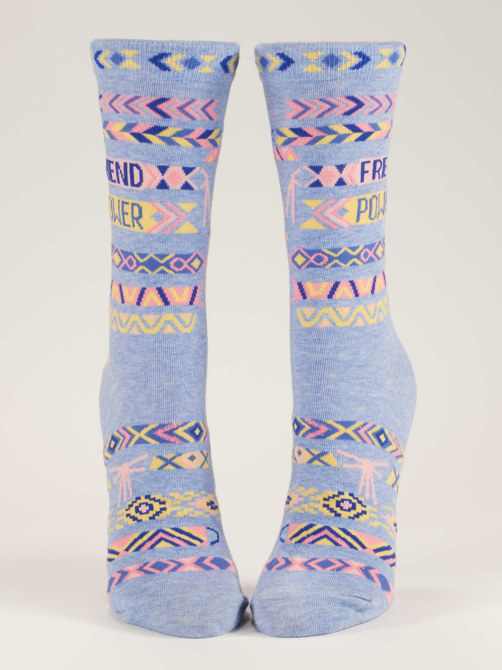 The Blue Q Friend Power W-Crew Socks are sustainable blue combed cotton socks with pink, yellow, and navy geometric patterns and "FRIEND POWER" on the front, displayed upright against a white background.
