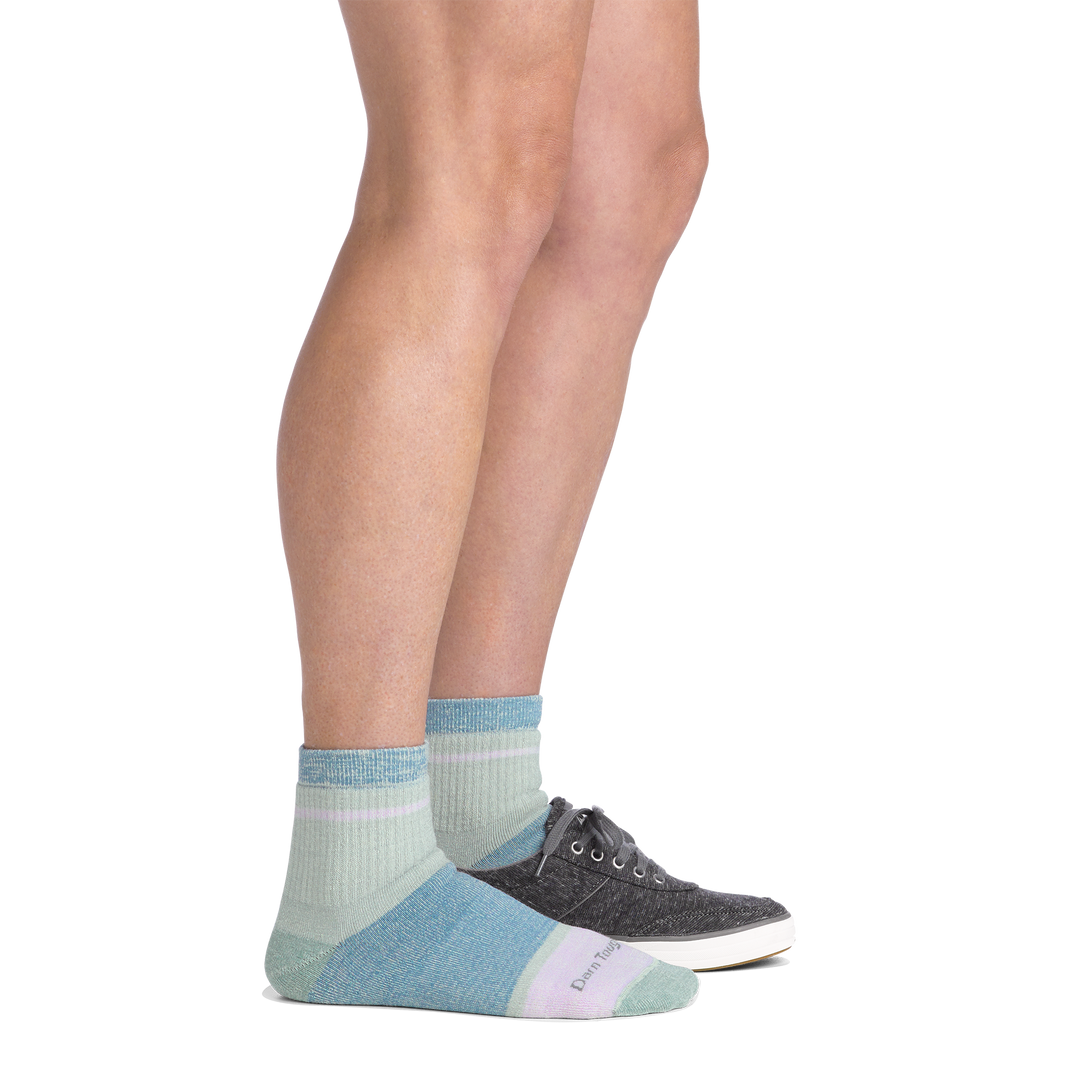 Side view of a woman with one shoe on wearing women&