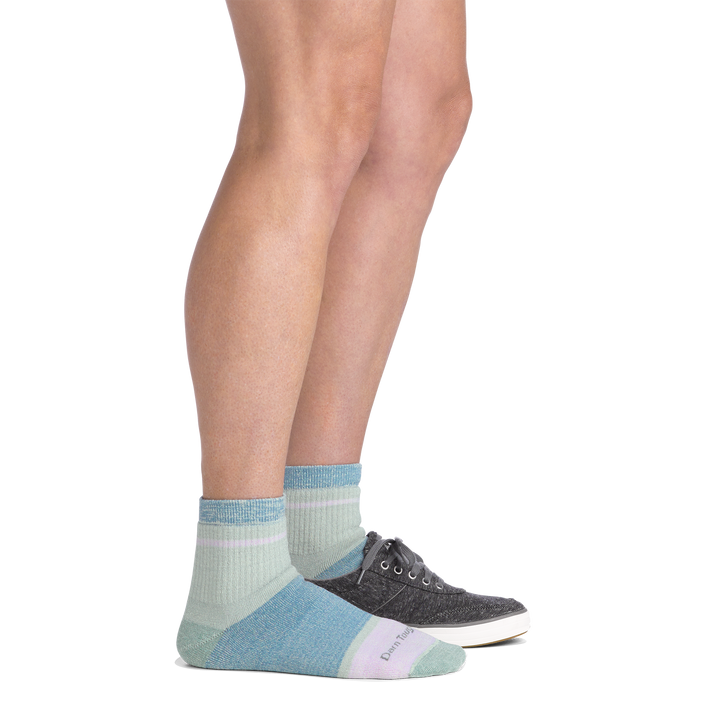 Side view of a woman with one shoe on wearing women&