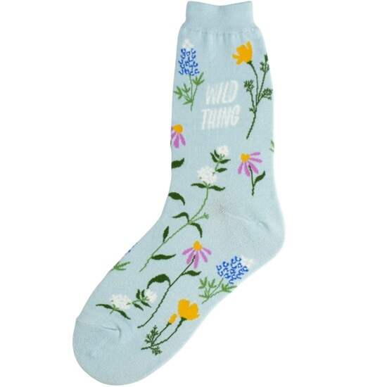 Women's wildflower crew socks flat lay reading Wild Thing in white script on pale blue