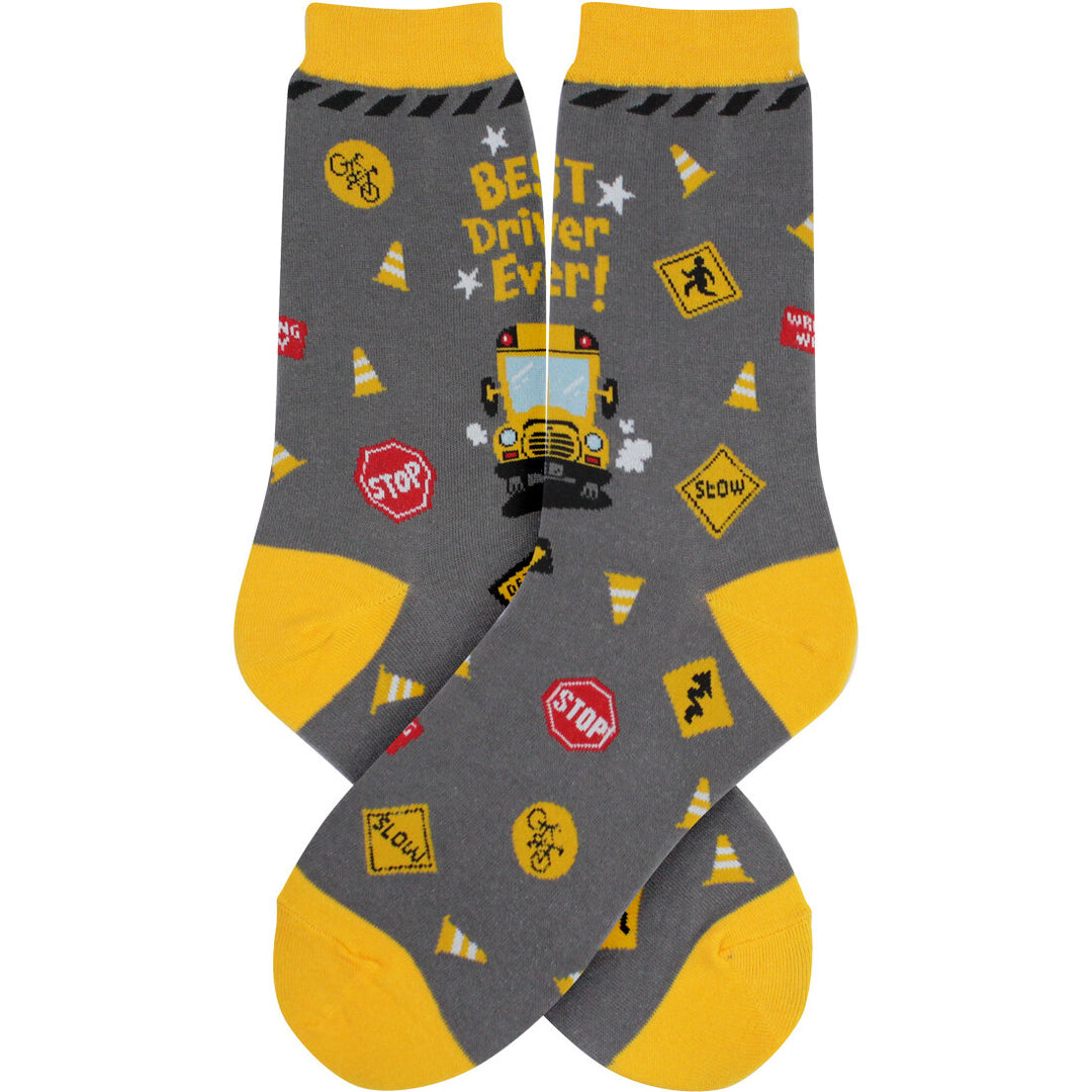 Women's bus driver crew socks with yellow school bus and road signs on grey, flat product shot