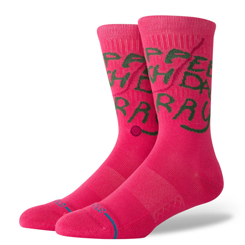 Women's pink Happee Birthdae crew socks worn, with scrawly green Hagrid-style text