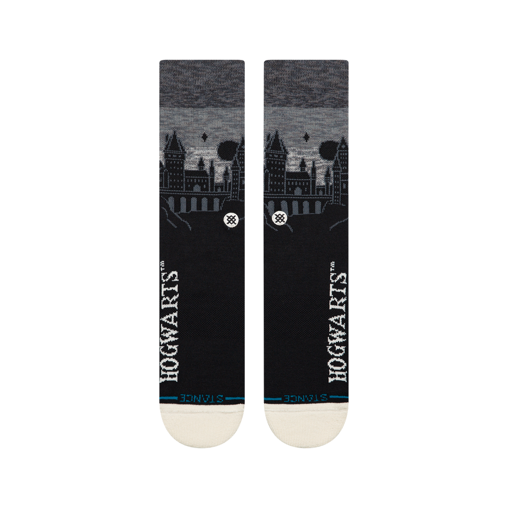 Women's Hogwarts Castle crew socks in black with a Hogwarts castle skyline against a heathered grey night sky, flat front view of the pair