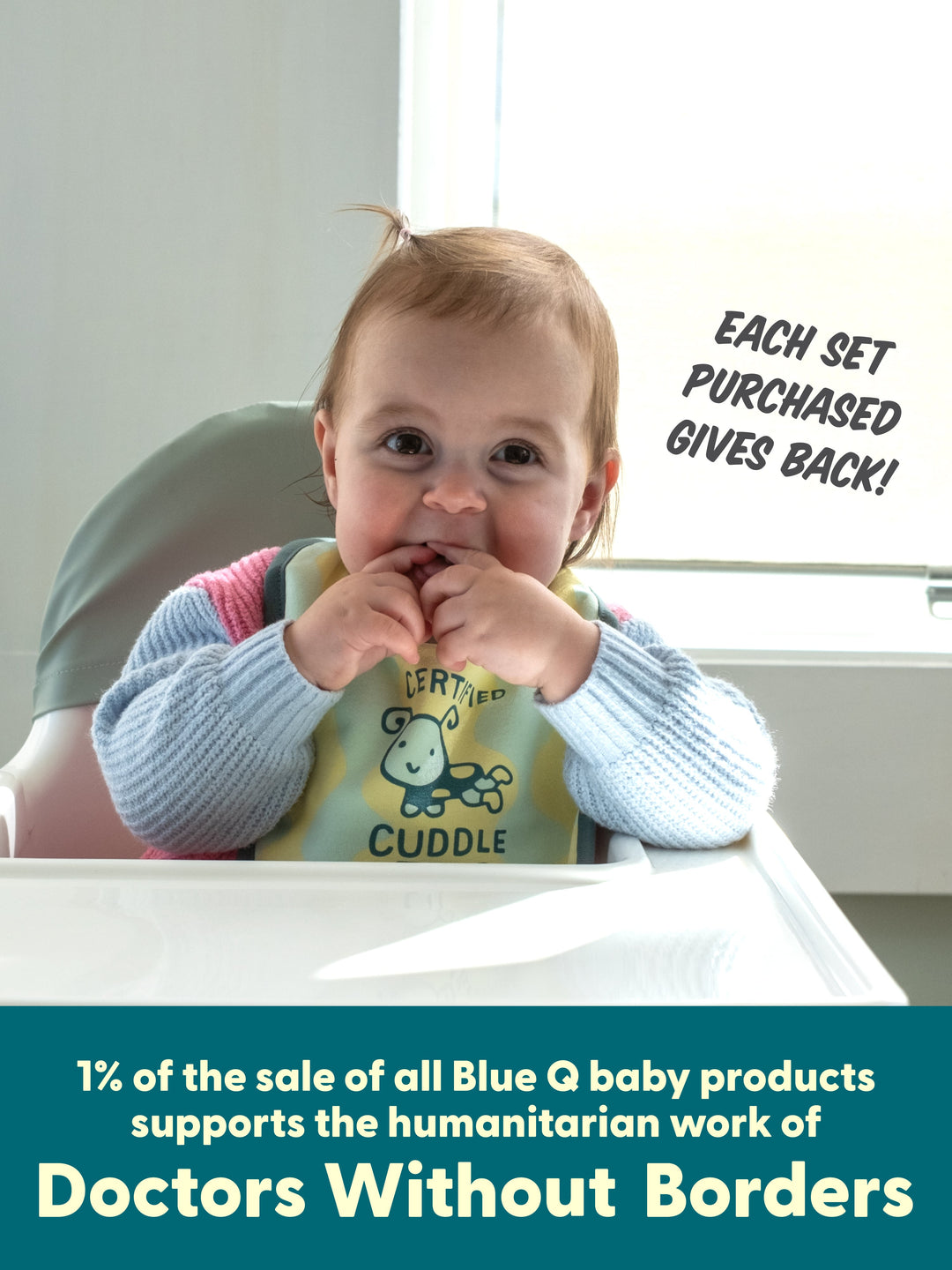 Baby in a high chair wearing the orange kids&