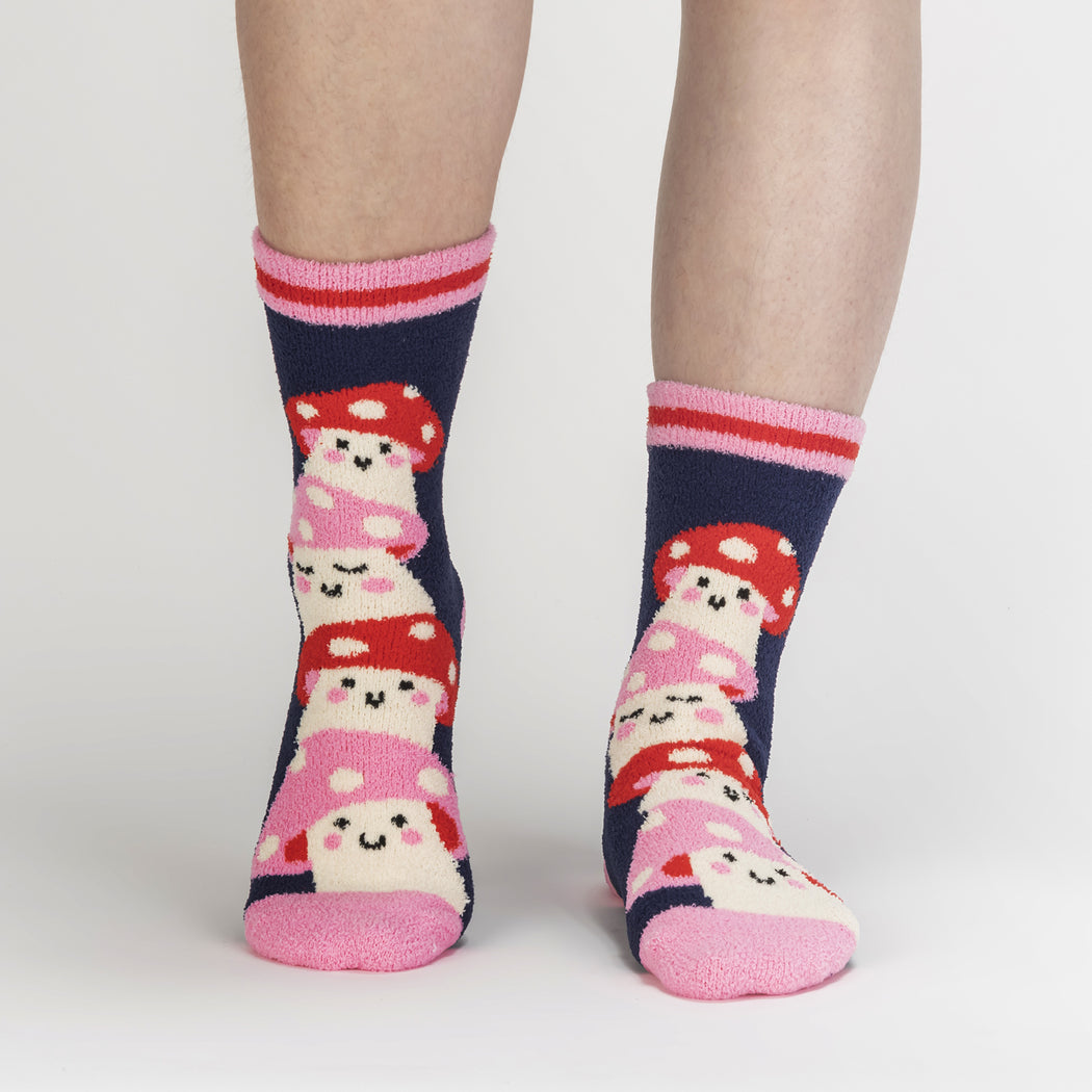 Women's fuzzy mushroom slipper socks in navy, worn front view on legs