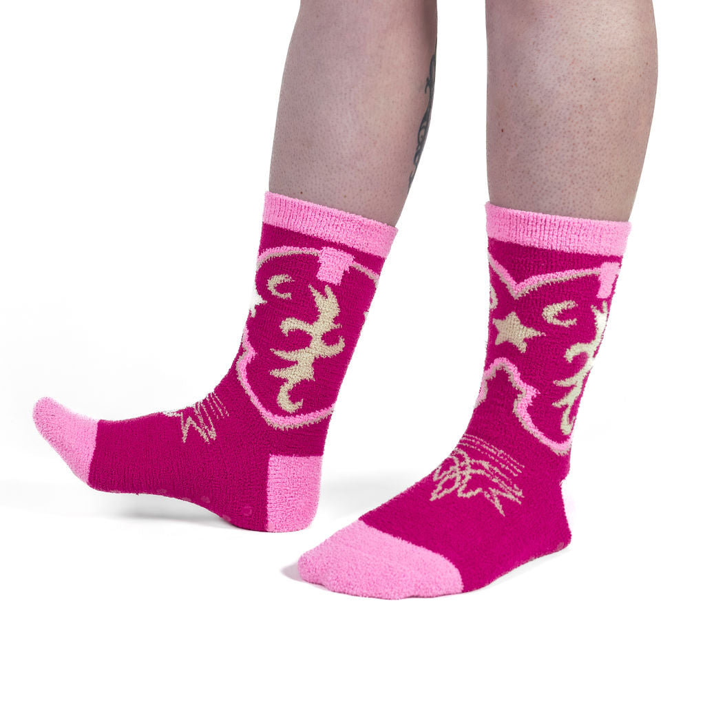 Boot Scootin' women's slipper socks with hot pink cowboy boots, model side view