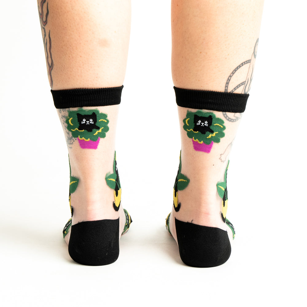Women's sheer cat-in-plant crew socks, clear mesh worn back view on legs