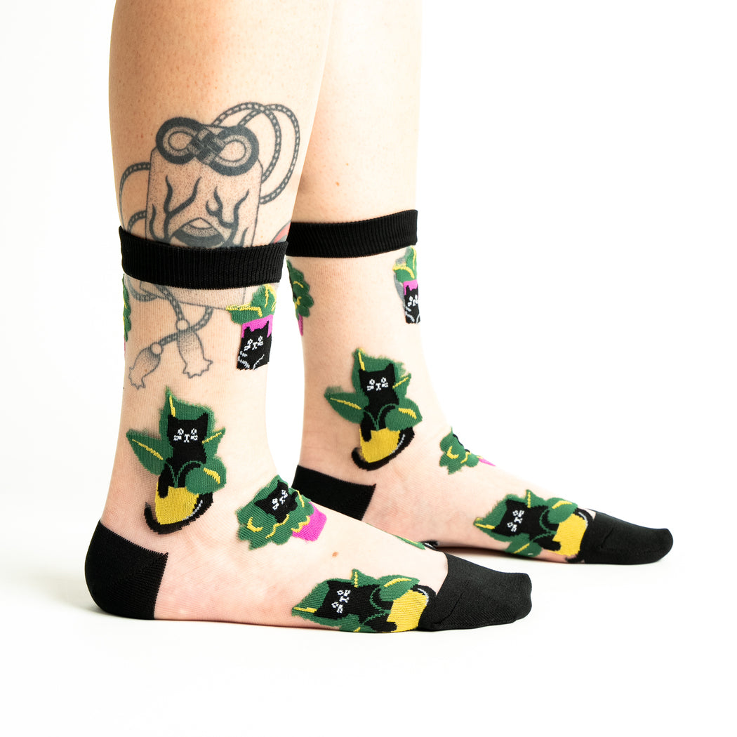 Women's sheer cat-in-plant crew socks, clear mesh worn side view on legs