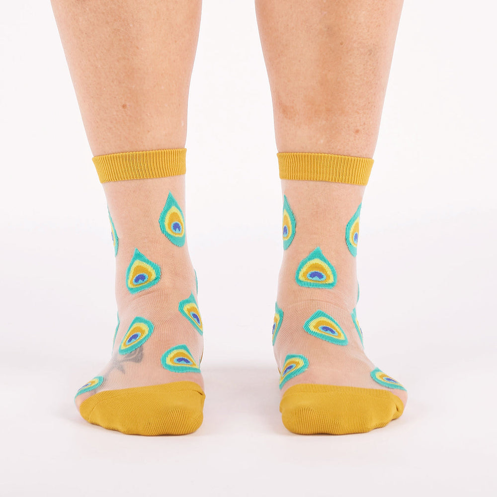 Women's peacock feather sheer crew socks worn, front view with mustard accents