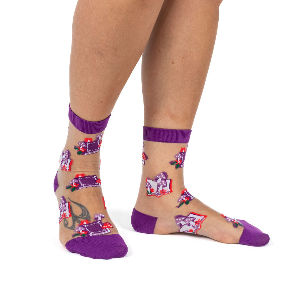 Reading Grows Your Mind women's sheer crew socks with books and mushrooms, model side view