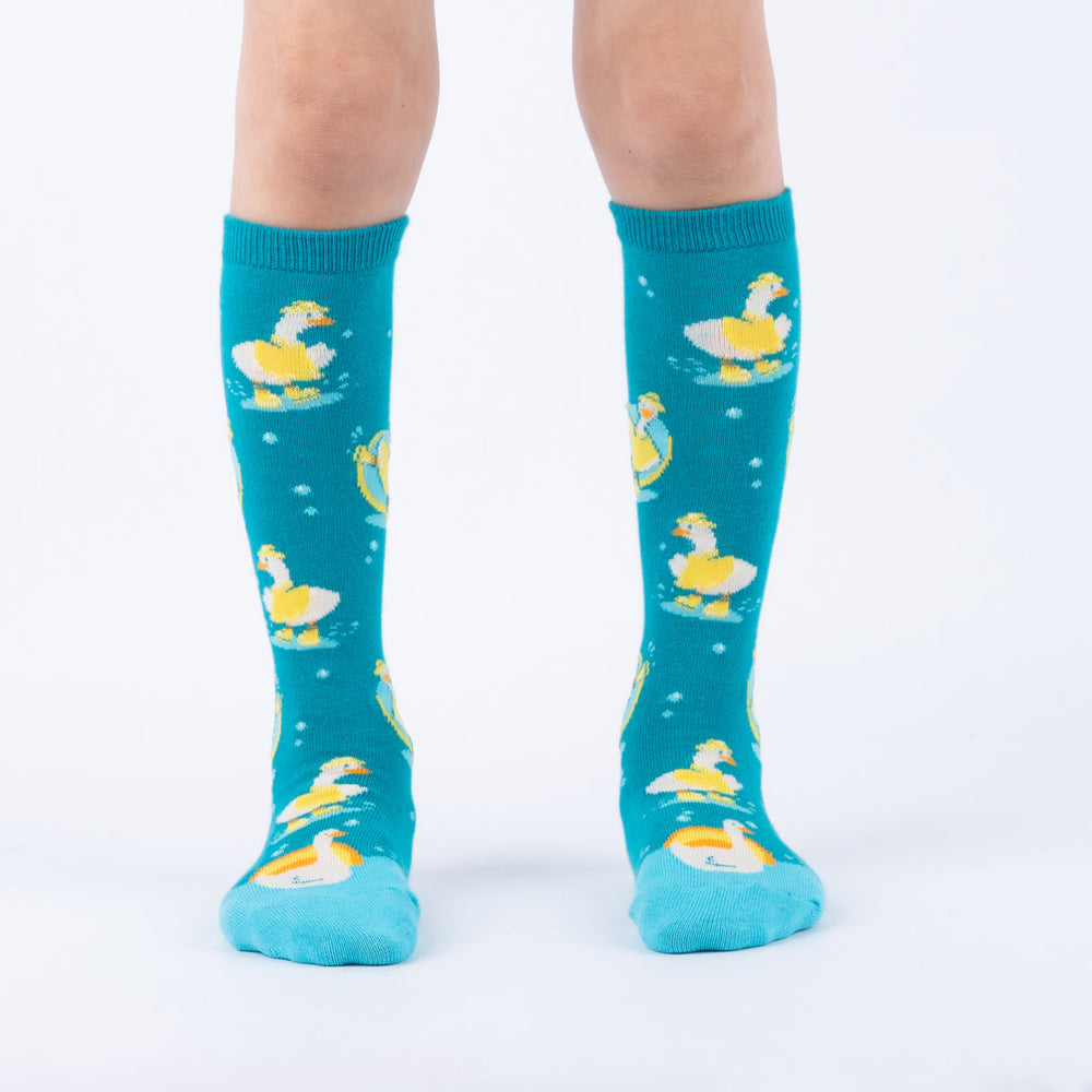 Kids' silly goose knee high socks worn, front view on child's legs