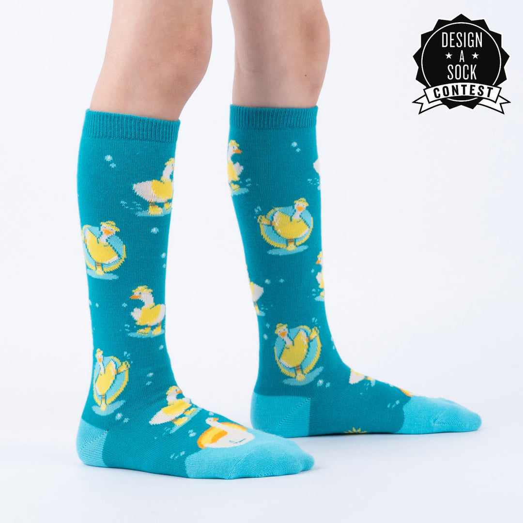Kids' silly goose knee high socks worn, side view, design-a-sock label