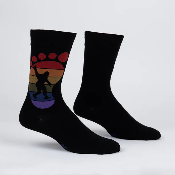 Men's Bigfoot crew socks flat lay, black with retro rainbow sunset and Squatch silhouette