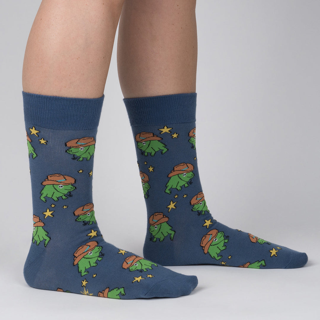 Men's cowboy frog crew socks worn, side view on denim-blue background