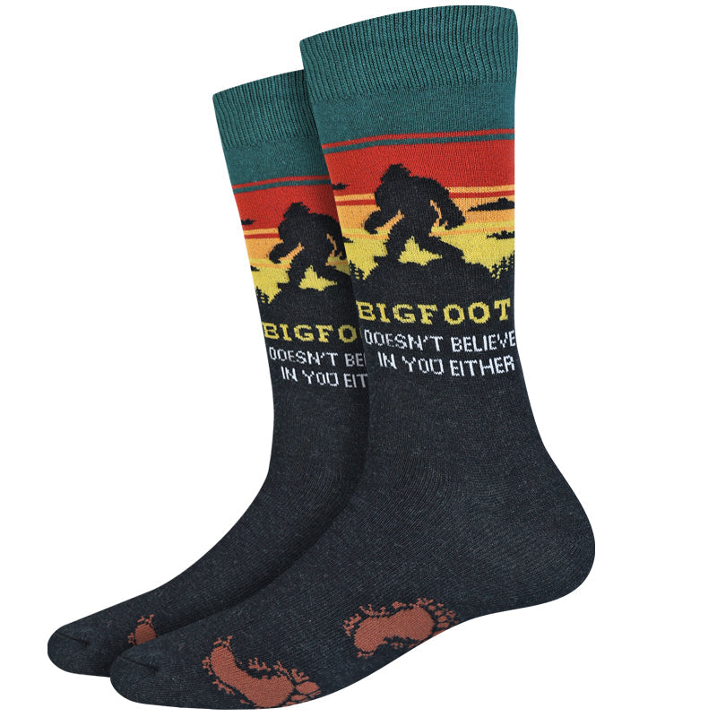 Men's Bigfoot crew socks, flat pair view with Sasquatch silhouette on sunset and witty text