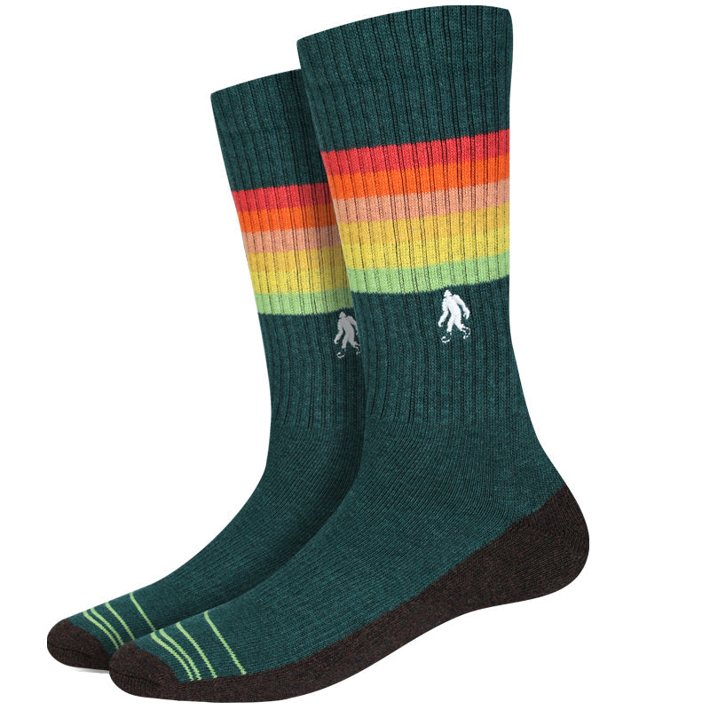 Men's active sunset stripe crew socks, flat pair view with rainbow gradient stripes and Bigfoot on green