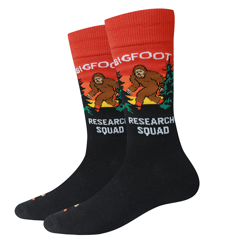 Bigfoot Research Squad black unisex crew socks with cryptid field gear, flat product shot