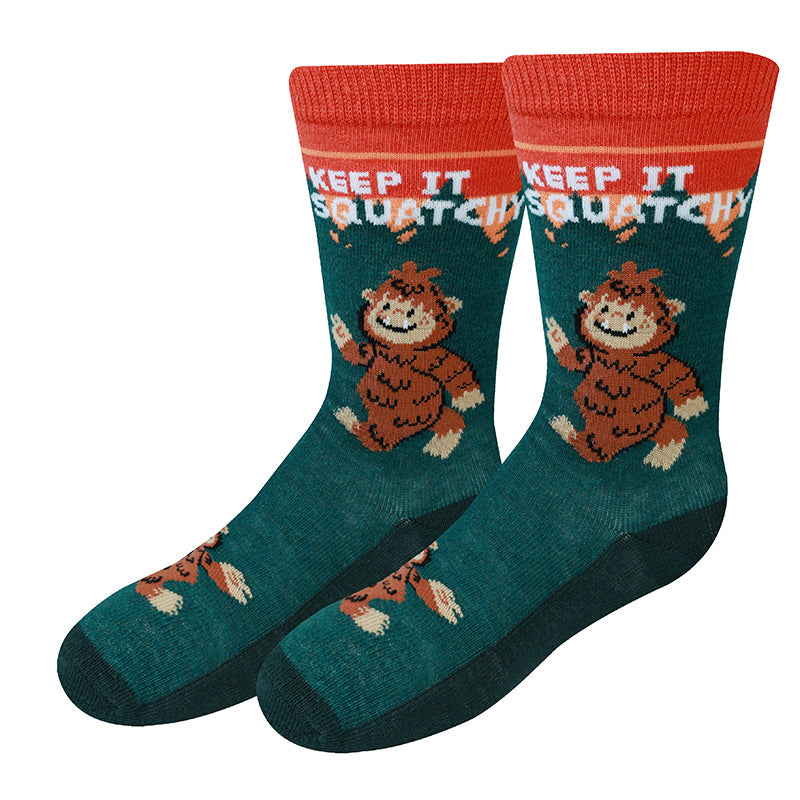 Keep it Squatchy green kids crew socks with thumbs-up Bigfoot, flat product shot