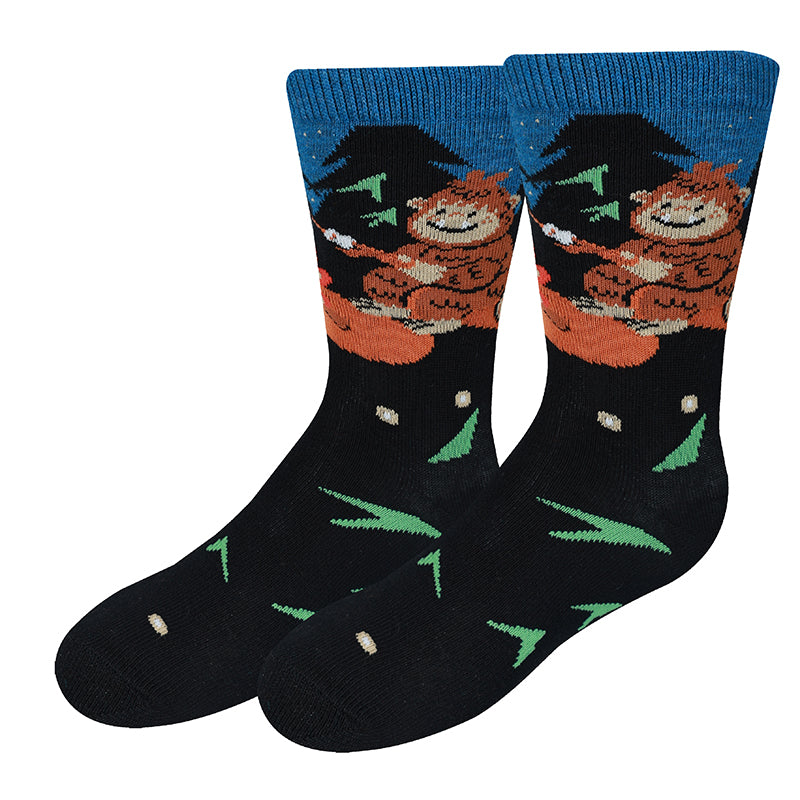 Campfire Bigfoot black kids crew socks with Bigfoot by a fire, flat product shot