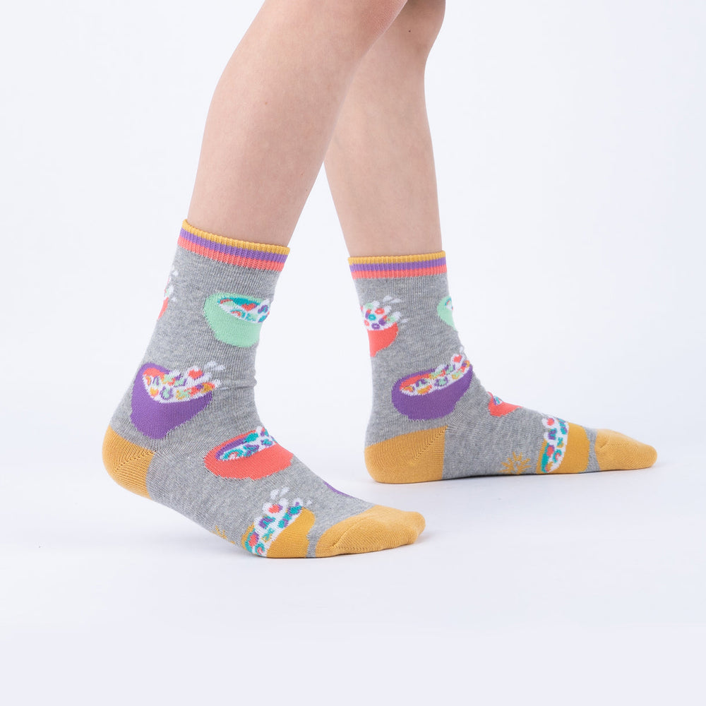 Child wearing gray cereal-bowl junior crew socks, side view