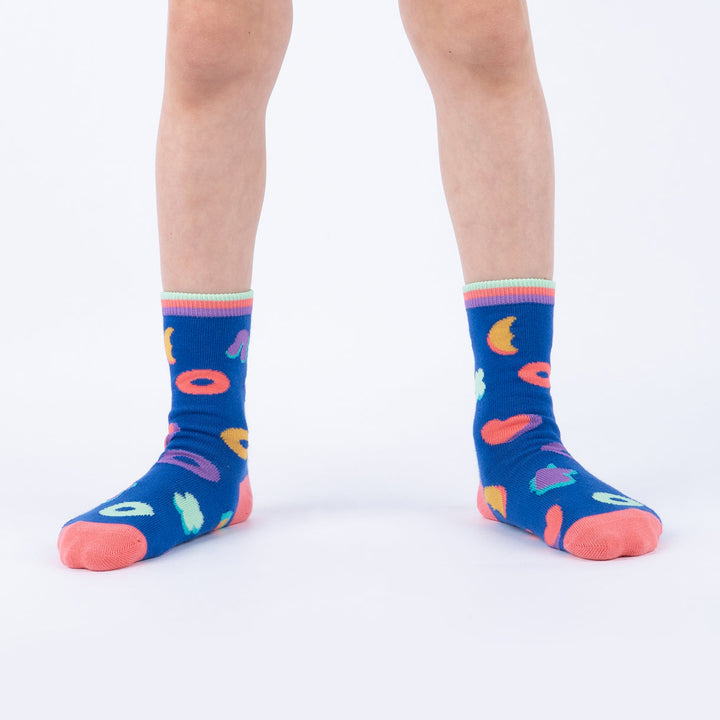 Child wearing navy marshmallow-shape junior crew socks, front view