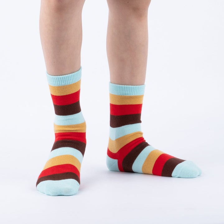 Child wearing caramel-striped junior crew socks, front view