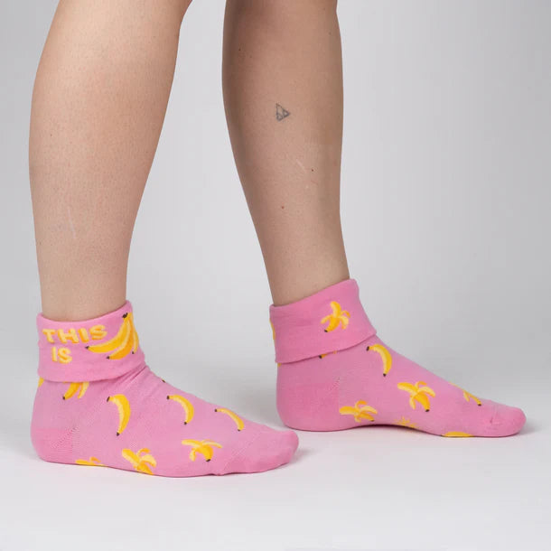 Women's banana turn-cuff socks worn, side view with cuff and banana pattern