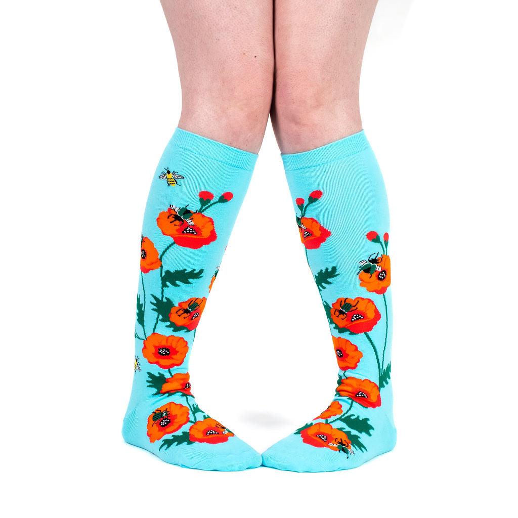 Popping In to Say Hello women's knee high socks with bees and poppies, model side view