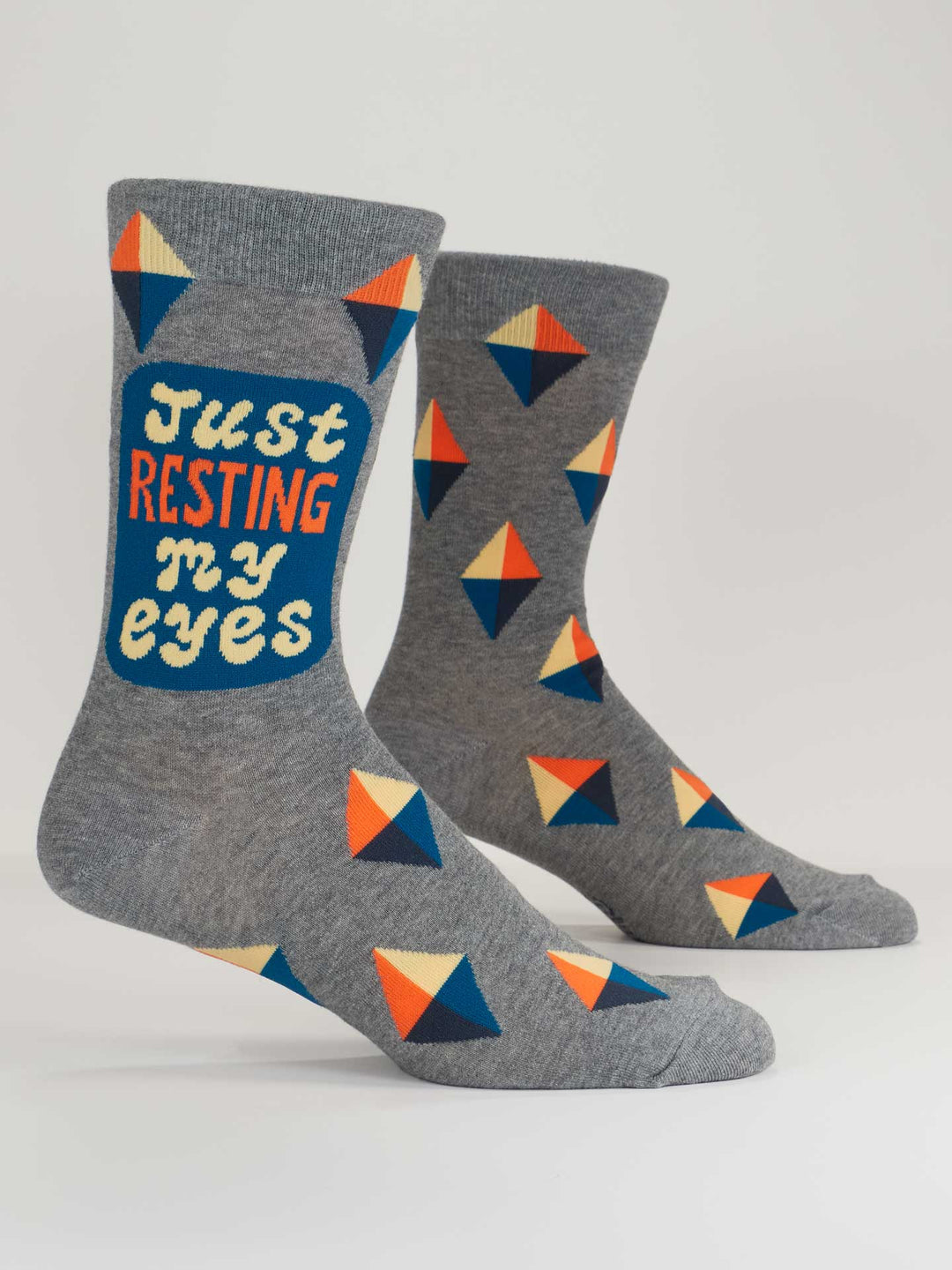 Blue Q Just Resting My Eyes M-Crew Socks: Gray combed cotton crew socks with colorful blue, orange, and cream geometric diamonds. "Just RESTING my eyes" is printed on the side for a playful look.