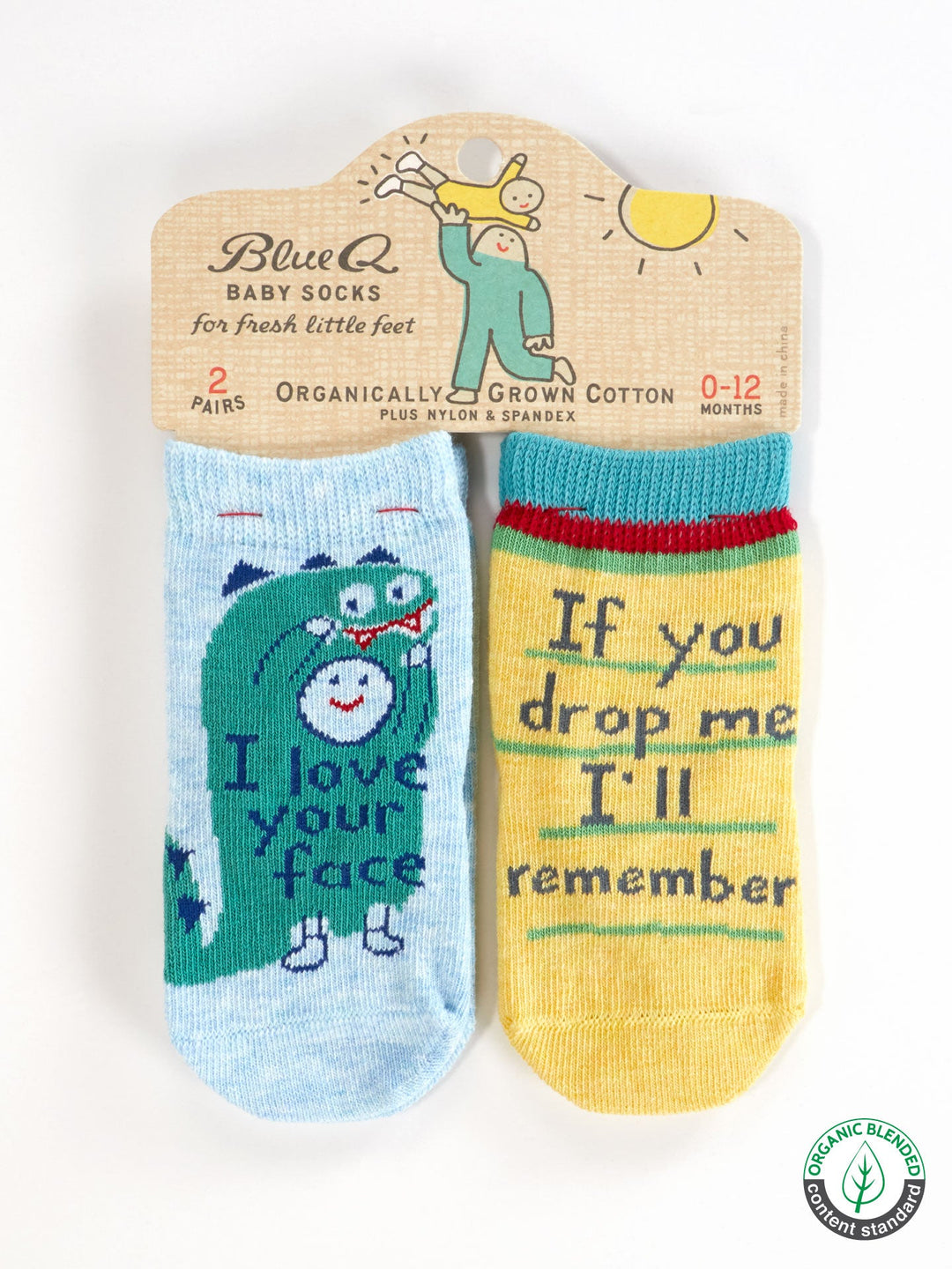 Blue Q’s “I Love Your Face/If You Drop Me I’ll Remember” baby socks set includes one blue pair with a dinosaur and one yellow pair with green trim. Made from OCS certified organic cotton, packaging features sun and baby designs.