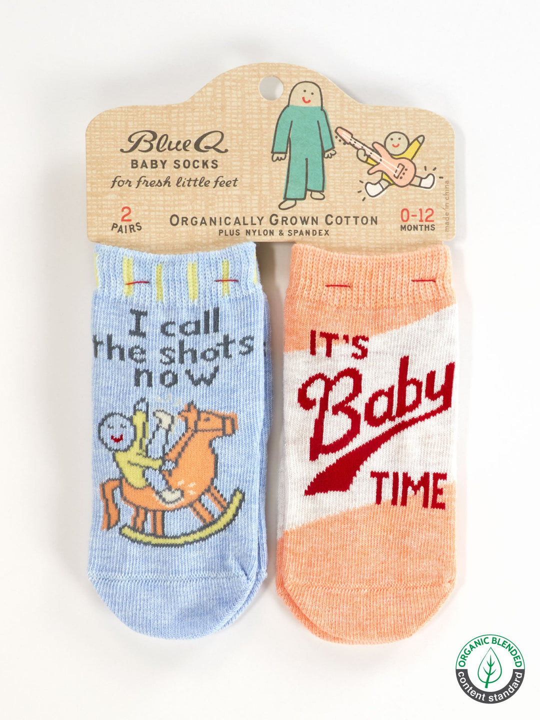 Blue Q's “I Call The Shots Now/It’s Baby Time” baby socks for 0–12 months include a blue sock with a cartoon baby on a rocking horse and an orange sock with “It’s Baby Time.” Perfect match for Family Pants or Organic Cotton Pants.