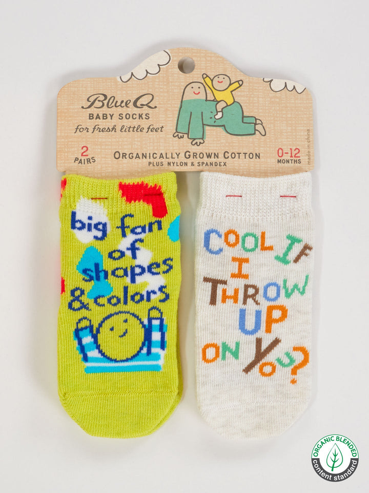 Blue Q’s "Big Fan Of Shapes &amp; Colors / Cool If I Throw Up On You?" baby socks: two playful pairs of OCS certified organic cotton, ages 0-12 months. One features blue shapes, the other says COOL IF I THROW UP ON YOU?. Perfect for tiny modern art lovers!.