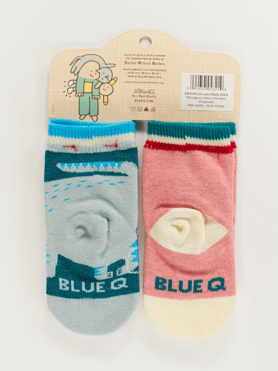 Cat Lover Jr./The Baby Did It. Baby Socks by Blue Q: a cute newborn sock set on a hanger card, featuring one blue sock with a whale and one pink with a cat, both with cream toes and heels and "BLUE Q" on the foot—perfect for little ones.