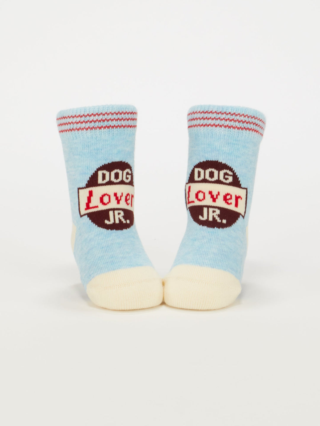 Blue Q Dog Lover Jr./Itty Bitty Buddies Baby Socks: Light blue organic cotton with cream toes and heels, featuring a red and black "DOG LOVER JR." design. Perfect for babies 0-12 months.