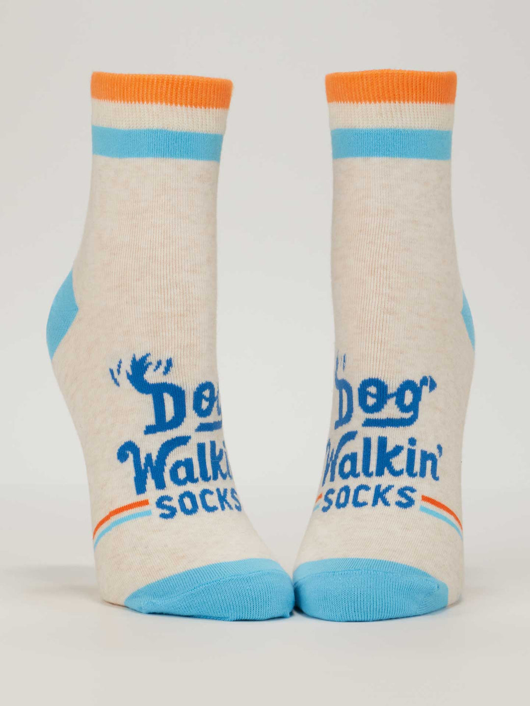 Blue Q Dog Walkin' W-Ankle Socks: Beige women’s socks with blue heels and toes, orange and blue stripes at the top, plus “Dog Walkin' Socks” and a blue paw print—perfect for your next stroll with your pup!.