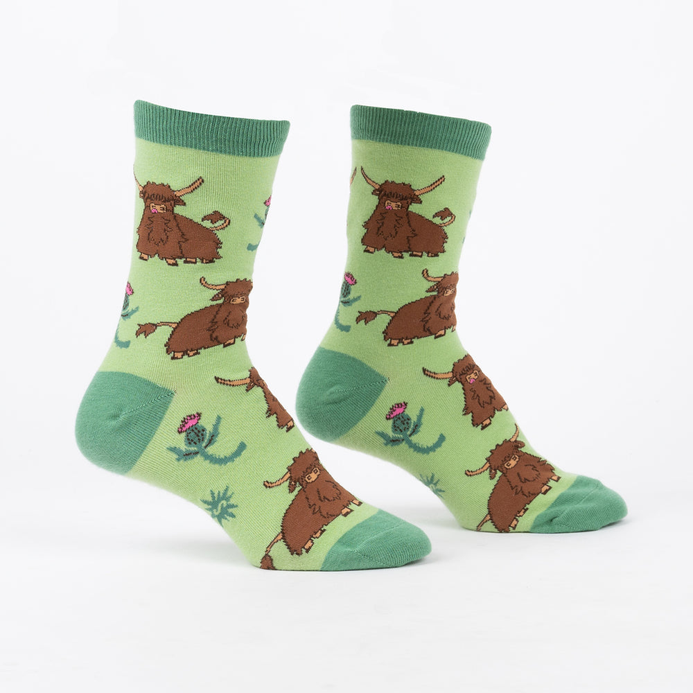 Women's Highland cow crew socks in green, flat pair front view