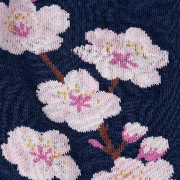 Women's cherry blossom crew socks close-up of pink blossoms with golden centers on navy