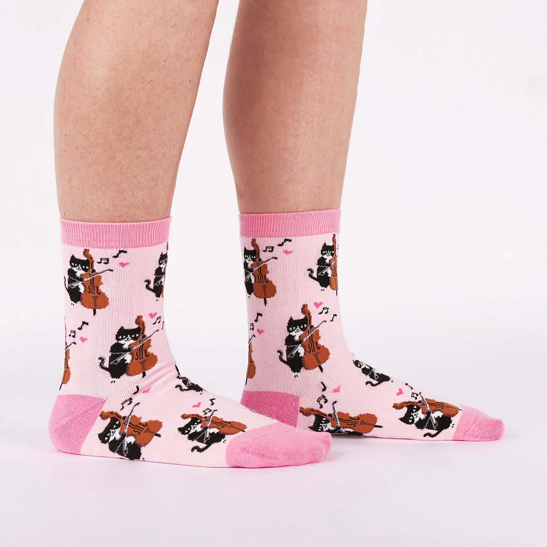 Women's musical cat crew socks worn, side view, pink with magenta trim