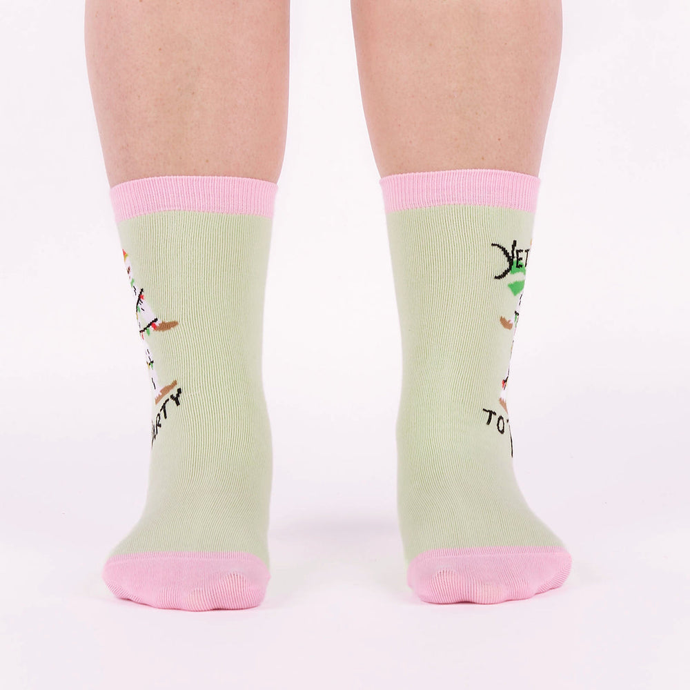 Women's holiday yeti crew socks worn, front view on legs