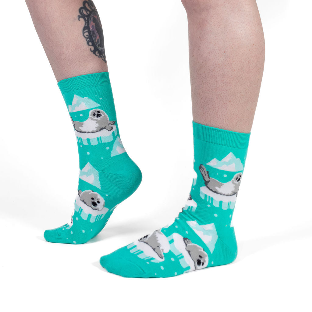 Seally Me! women's crew socks with seals on icebergs, model side view