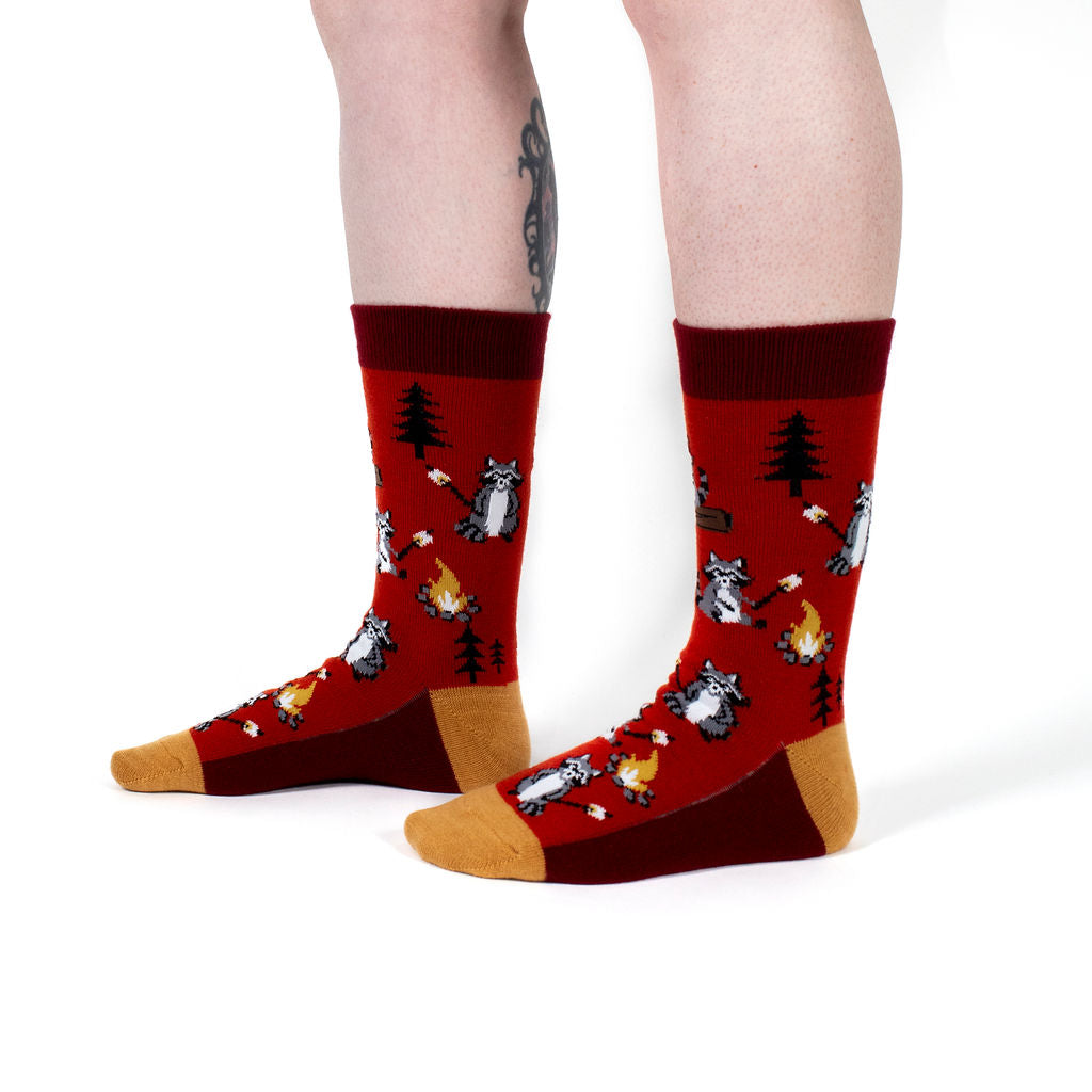 I Need S'more Raccoons unisex wool crew socks with campfire raccoons, model side view