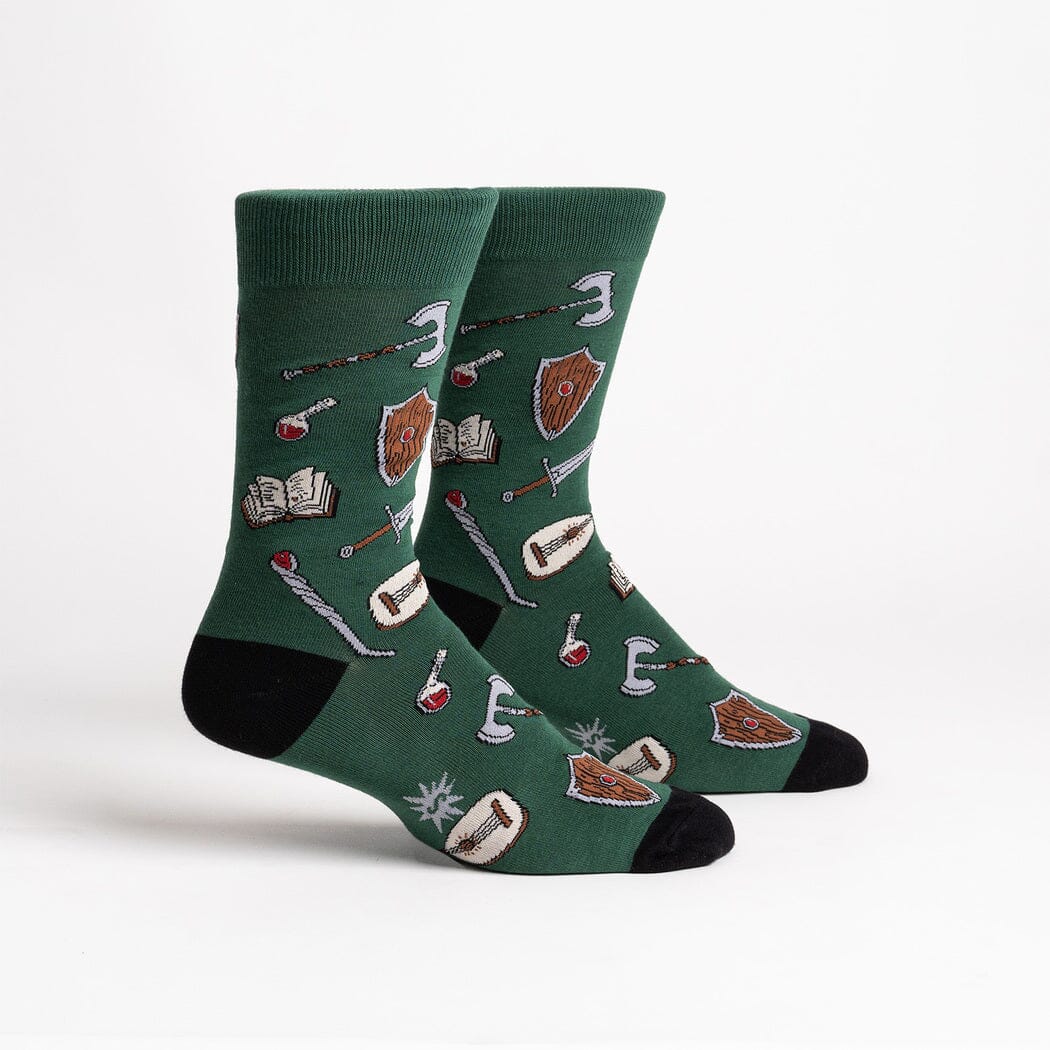 Men's Adventure At Your Feet crew socks, flat pair view, axes, shields, swords, and potions on green
