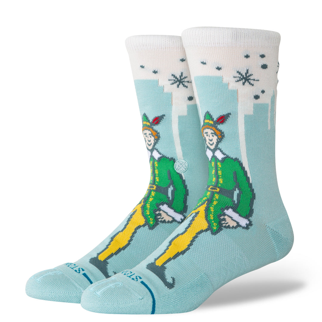 Women's Big City Elf crew socks, angled view of Buddy character on mint skyline